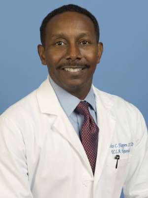 Head shot of Dr. Charles Flippen in a white coat smiling at camera