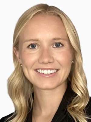 Smiling professional headshot of a blonde woman in a black blazer.
