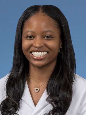Head shot of Christina Ramsey in a white coat, smiling at camera