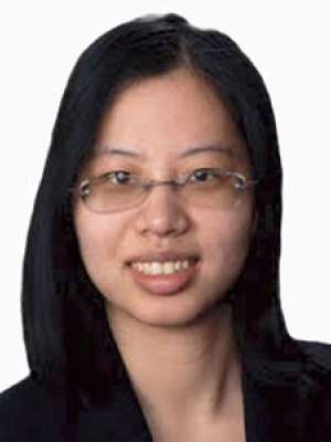 Janet Wang, professional headshot, smiling and wearing glasses