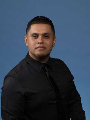 headshot of Ernesto Lopez in black shirt