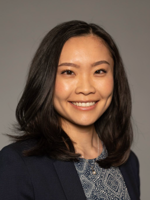 Head shot of Kristine Khieu in business attire, smiling at camera