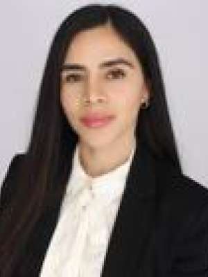 Headshot of a person in black blazer and white blouse.