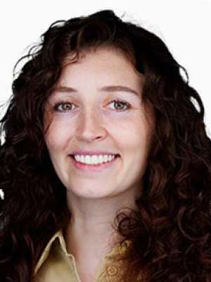 Smiling woman with dark curly hair on white background