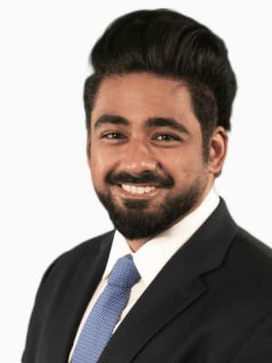 Keshav Goel headshot, smiling in suit and blue tie