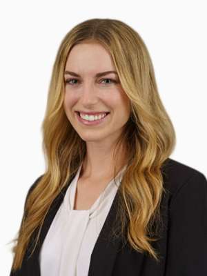 Smiling professional woman with long blonde hair wearing blazer and white blouse