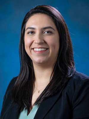 Head shot of Brenda Gutierrez in business attire, smiling at camera