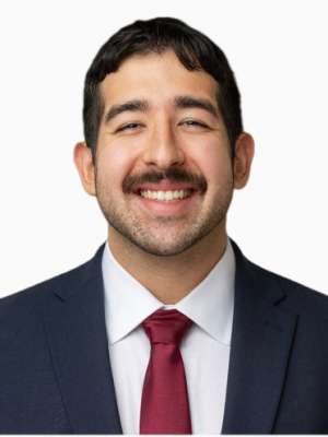 Felipe Gonzalez Gutierrez, smiling headshot in suit and tie