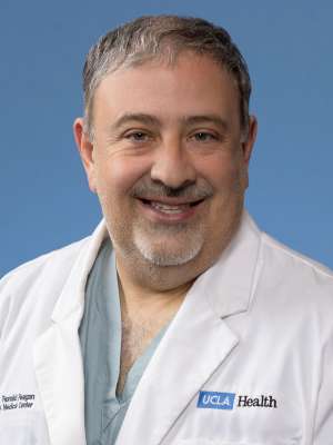 A headshot of Morris Salem, MD in a lab coat in front of a blue background