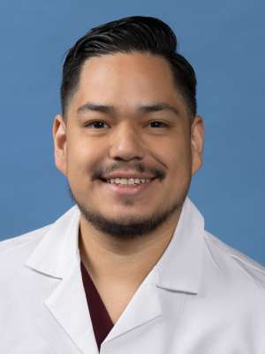 Giancarlo Cardoza, MD in a white lab coat