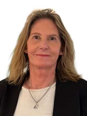 Smiling woman in blazer wearing pendant necklace against white background