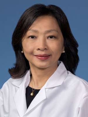 Nwe Nwe Soe, MBBS, PhD, F(ACHI) in a white lab coat