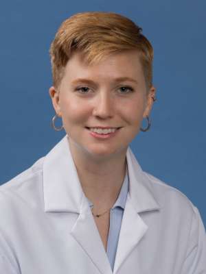 Head shot of Mallory Blackwood in white lab coat, smiling at camera