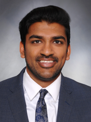 Head shot of Rohan Rao in business attire, smiling at camera