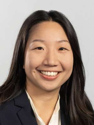 Head shot of Jessica Lam, MD, PhD in business attire, smiling at camera