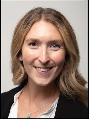 headshot of Maya Tarasenko wearing a white blouse and black blazer in front of a white background
