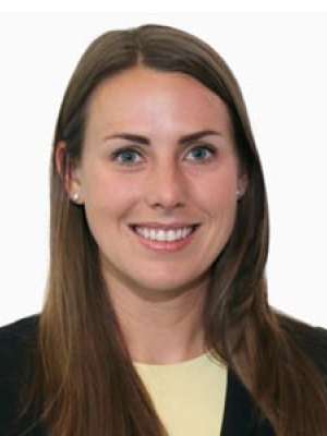 Kelsey Wanhainen headshot smiling in blazer against white background