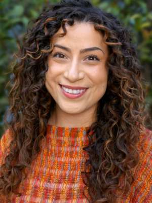 Headshot of Stephanie Auirre with Shrubs in Background