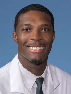 Timothy Harris, PhD in a white lab coat