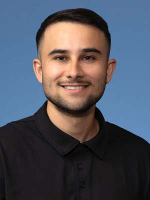 Man in black shirt smiling