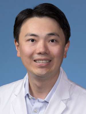 Xueyang Pan, PhD in a white lab coat