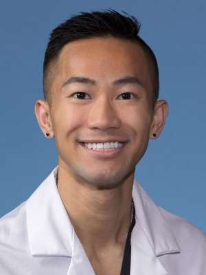 Donald Doanman, MD, PhD in a white lab coat