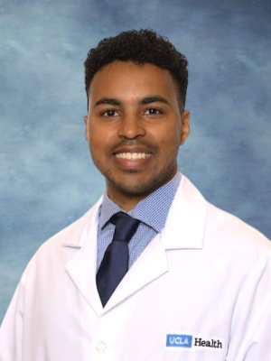 headshot of Dr. Ehab Bahrun wearing a lab coat in front of a blue background
