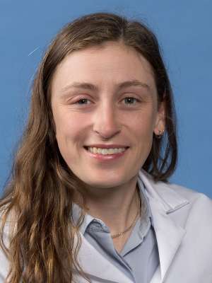 Mackenzie Collins, PhD in a white lab coat