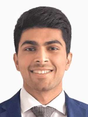 Kushagra Patel, young man smiling in a suit and tie