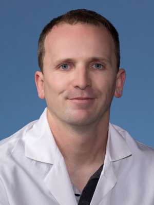 Harry Pickering, PhD in a white lab coat