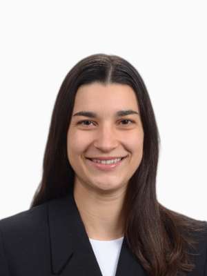 Alizee Natsoulis smiling headshot wearing a blazer
