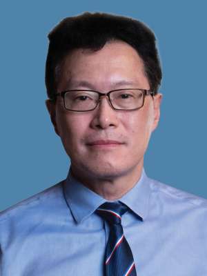 Person in blue shirt and striped tie on blue background
