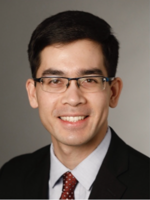 John Rodgers headshot wearing suit and tie against a neutral background