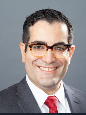 Headshot of Dr. Hugo Torres in gray suit