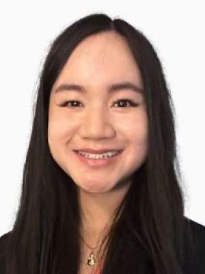 Joanne Newens MD smiling headshot with long dark hair and black blazer