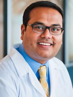 Headshot of Aditya Bardia, MD, MPH, in a white coat and tie.