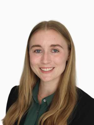 Grace Hildebrand headshot, smiling with a neutral white background.