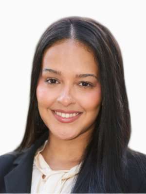Smiling woman with long dark hair wearing a blazer in a professional headshot.