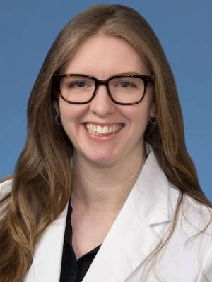 Head shot of Rachel Eisenbarth in white lab coat, smiling at camera