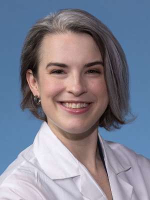 Jynna McMillin, MD in a white lab coat