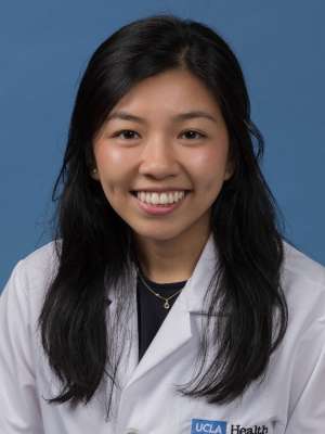 Head shot of Elaine Ramirez in white lab coat, smiling at camera