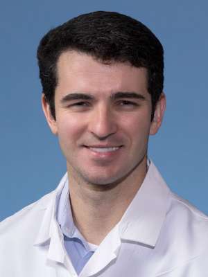 Sam Cockey, MD in a white lab coat