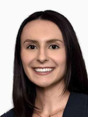 Allyson Malone smiling headshot with dark hair and blazer