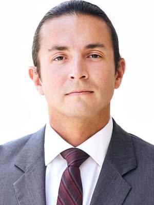 Professional headshot of Benjamin Ellingson, wearing a suit and tie.