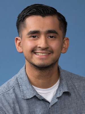 William Vizcarra Headshot on Blue Background