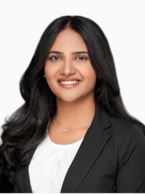 Smiling woman in black blazer and white blouse, head-and-shoulders portrait
