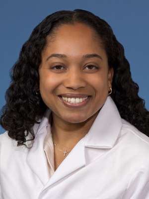 Head shot of Rehana Persaud, MD, MS in white coat, smiling at the camera