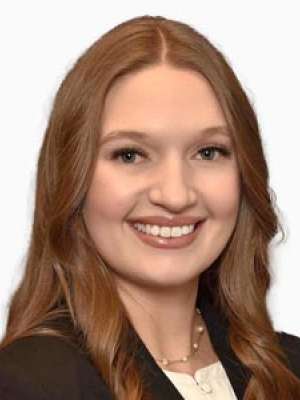 Ravellette Keeley smiling headshot in blazer