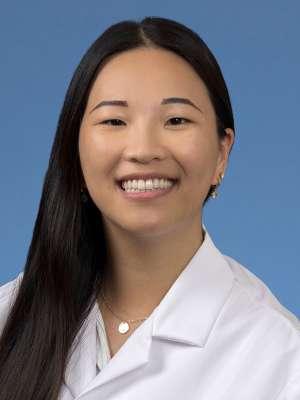 Head shot of Joyce Lee in a white coat, smiling at the camera