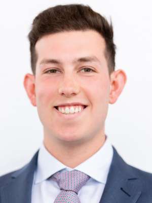 Smiling man in suit and tie headshot